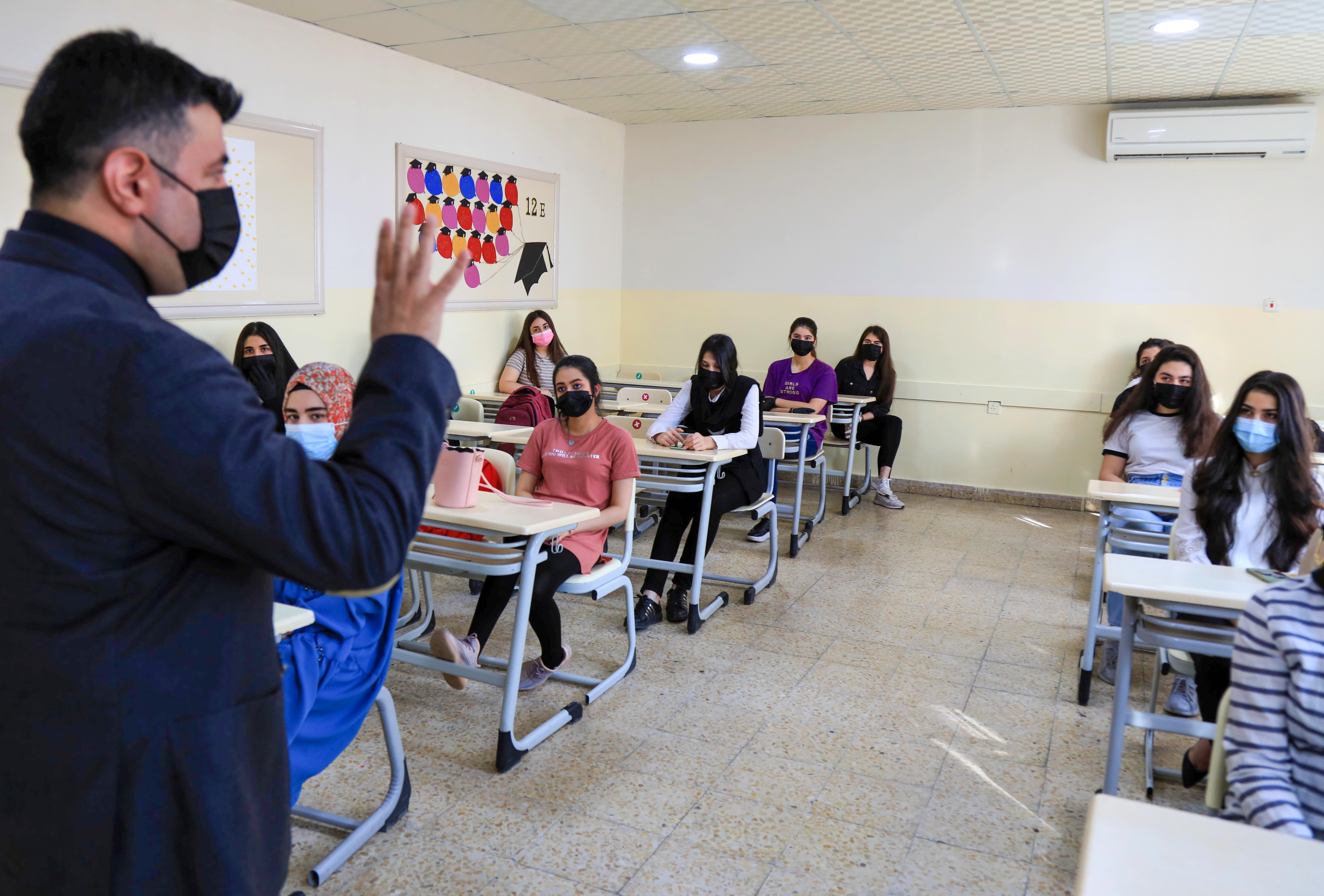 Mask-clad students listen to their instructor on the first day of the new school year in the Kurdistan Region amid the coronavirus pandemic, Sept. 27, 2020. (Photo: AFP/Safen Hamid)